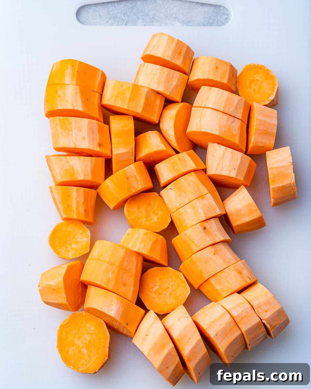 Caramelized Sweet Potatoes 5 Raw sweet potato sliced into uniform rounds, ready for seasoning.