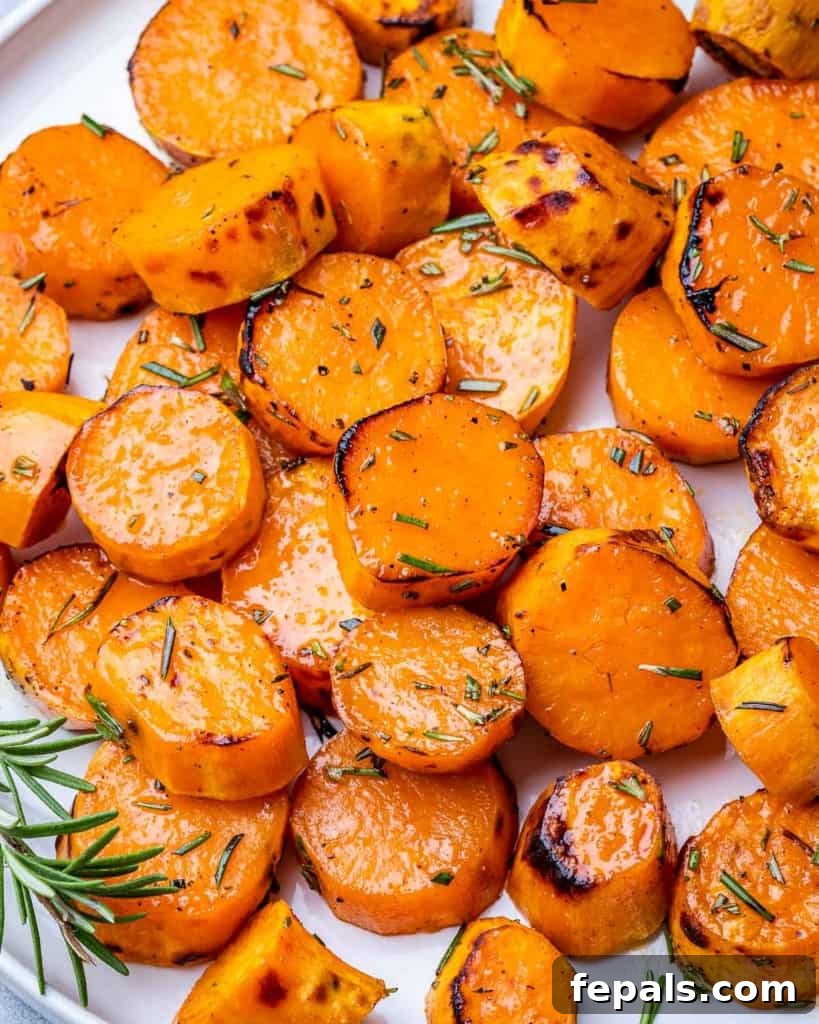 Caramelized Sweet Potatoes 9 Close-up of golden roasted sweet potato slices on a white plate, ready to be served.