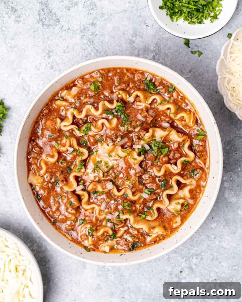 Hearty Lasagna Soup 9 A top-down view of lasagna soup in a pristine white round bowl, showcasing its rich texture and delicious toppings, ready to be enjoyed.