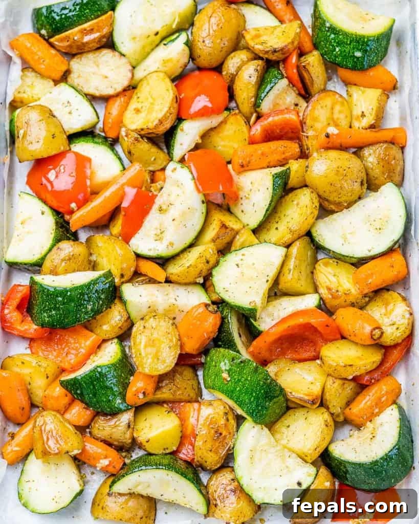 Garlic roasted vegetables on a sheet pan, perfectly golden and tender.