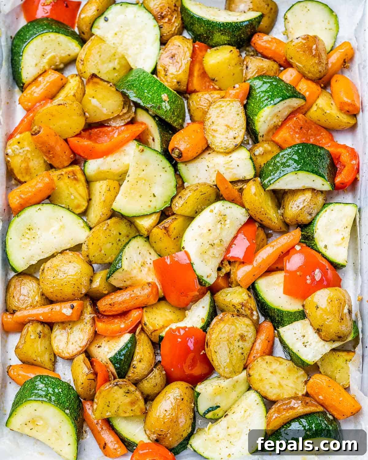 Beautifully roasted vegetables on a pan, fresh out of the oven.