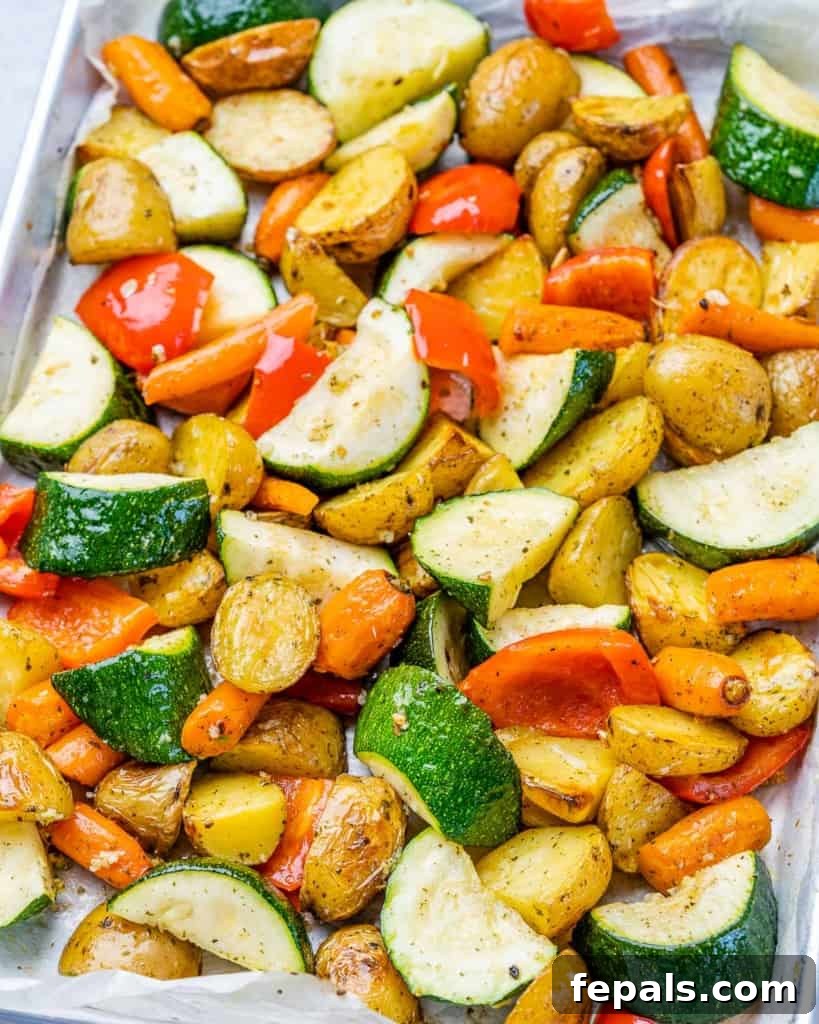 A vibrant variety of roasted vegetables beautifully arranged on a sheet pan.