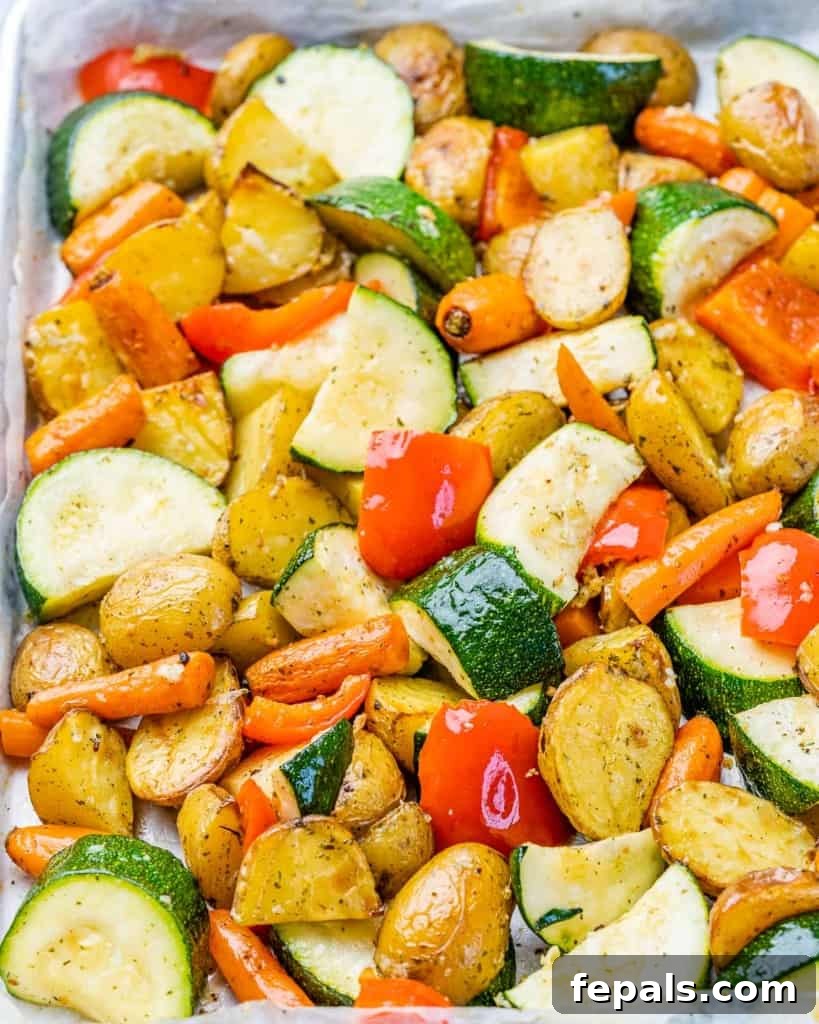 Cooked garlic roasted vegetables ready to be served on a sheet pan.