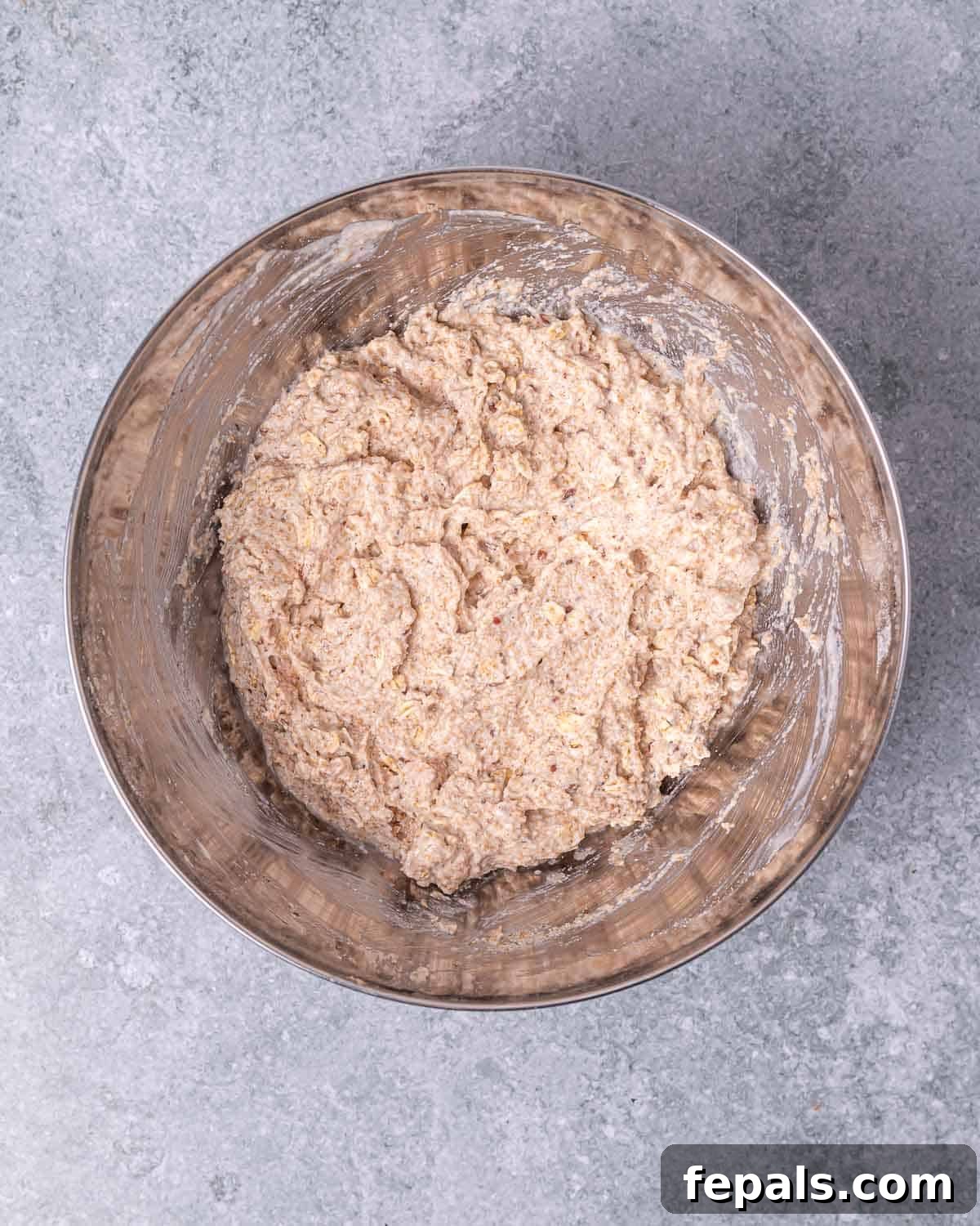 Adding wet ingredients to dry ingredients in a large bowl.