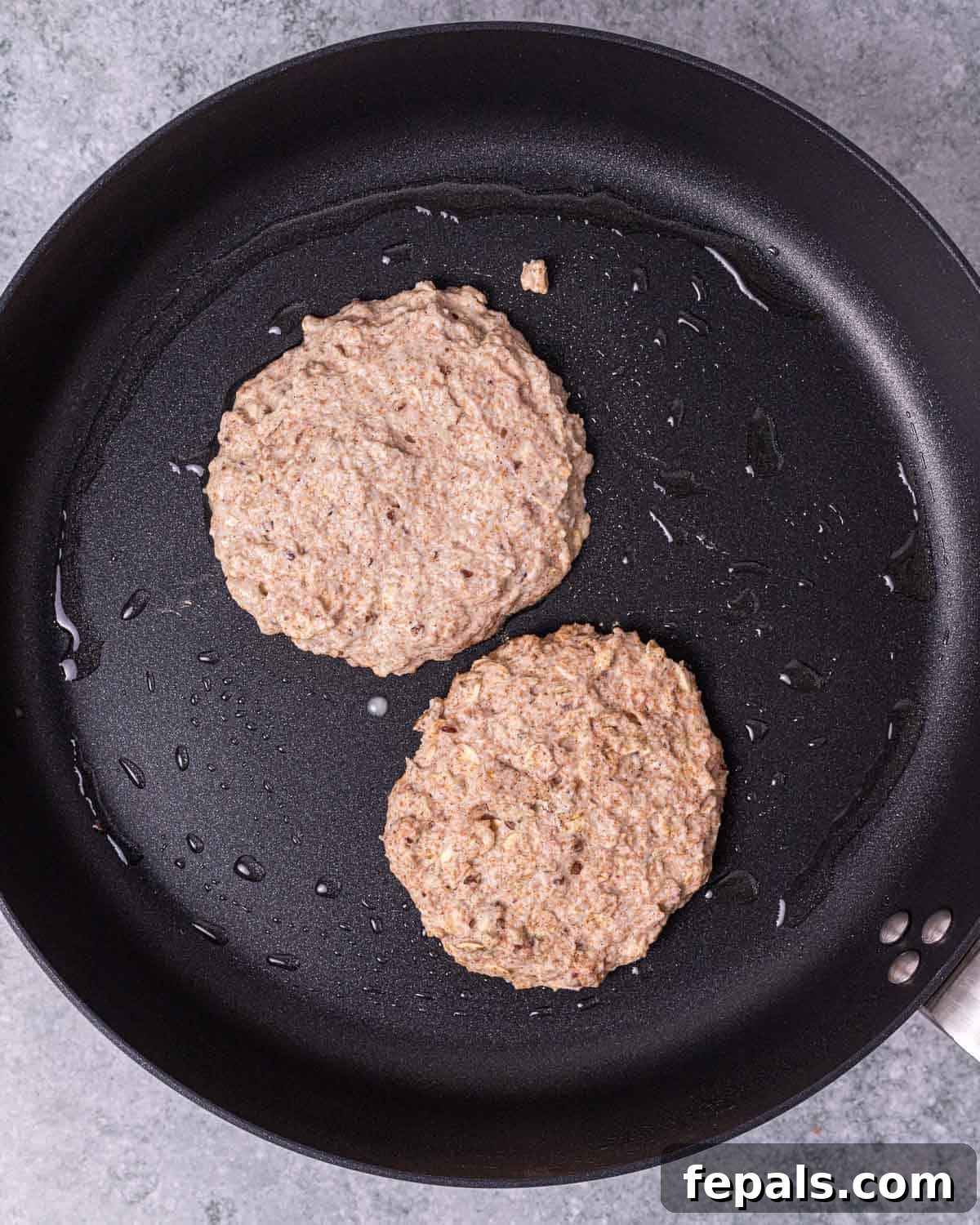 Cooking pancakes on a large skillet.