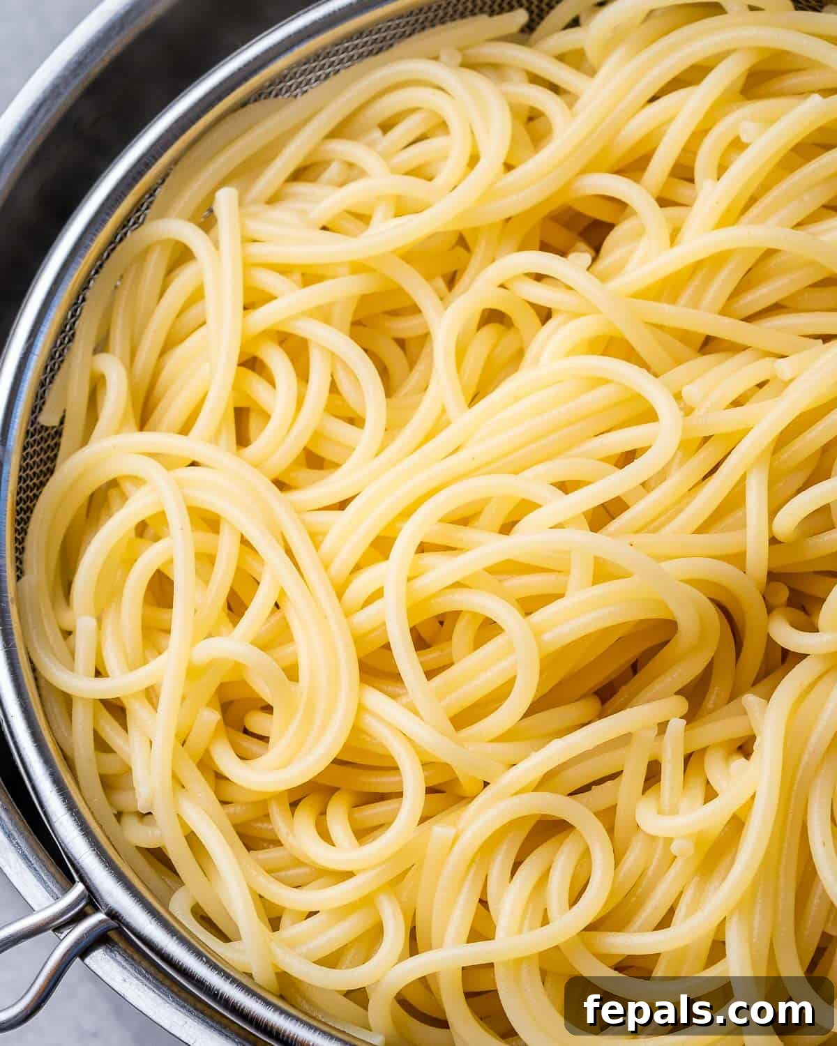 Luscious Vegan Lemon Pasta 5 Spaghetti in a colander, freshly drained and ready for the sauce.