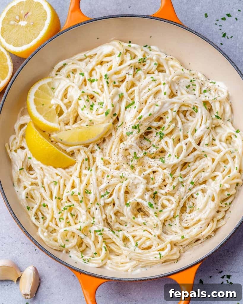 Luscious Vegan Lemon Pasta 8 Top view of creamy spaghetti expertly tossed in an orange skillet, ready to be served.