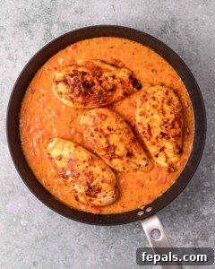 Skillet Peri Peri Chicken: Creamy & Zesty 19 Simmering chicken in peri peri sauce in a pan.