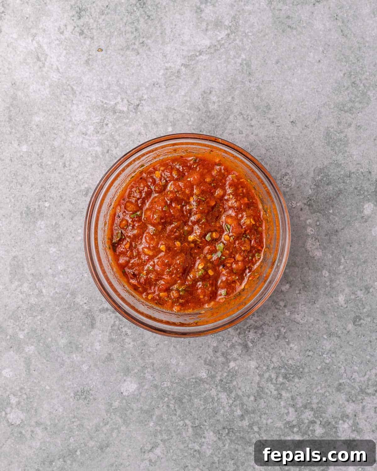 Skillet Peri Peri Chicken: Creamy & Zesty 6 A vibrant red tomato-based peri peri marinade in a small mixing bowl.