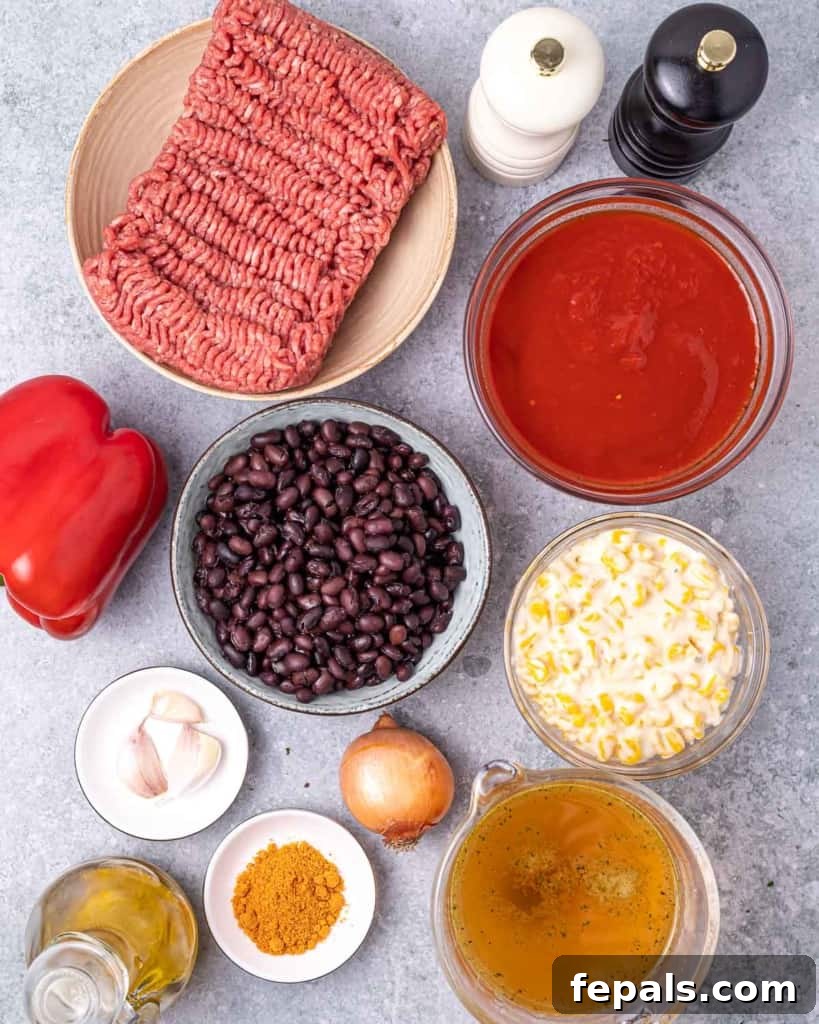 Southwest Creamy Beef Enchilada Soup 4 A collection of fresh ingredients laid out, including ground beef, black beans, bell peppers, onions, and spices, ready to make beef enchilada soup.