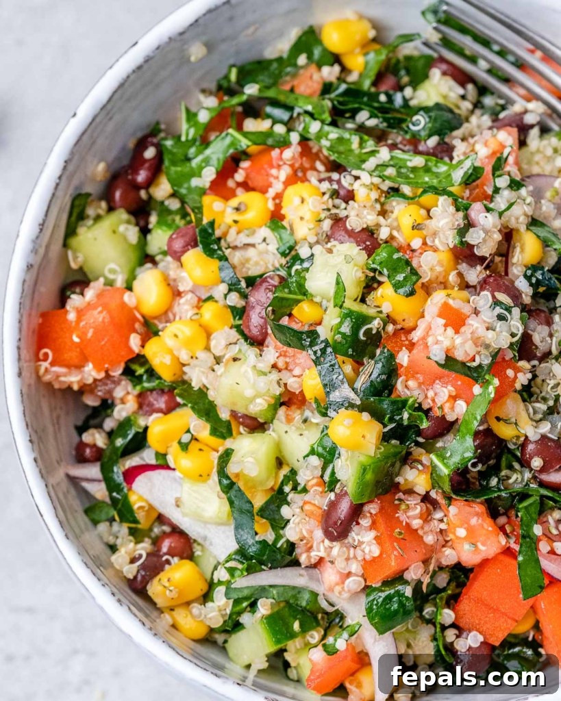 Tuscan Kale Power Jar 3 A fresh salad with vibrant tomatoes, golden corn, and crisp kale in a white bowl, ready to be enjoyed.