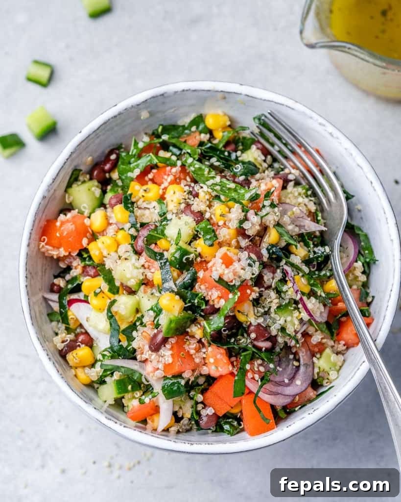 Tuscan Kale Power Jar 8 A delectable kale salad served in a white bowl, ready with a fork for enjoyment.