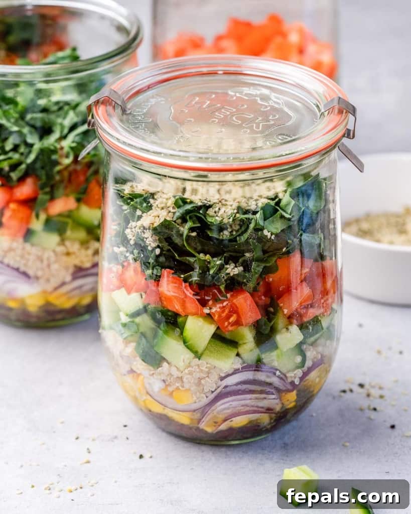 Tuscan Kale Power Jar 10 A perfectly layered Italian Kale Salad Jar, featuring vivid kale, tomatoes, red onion, and cucumbers.
