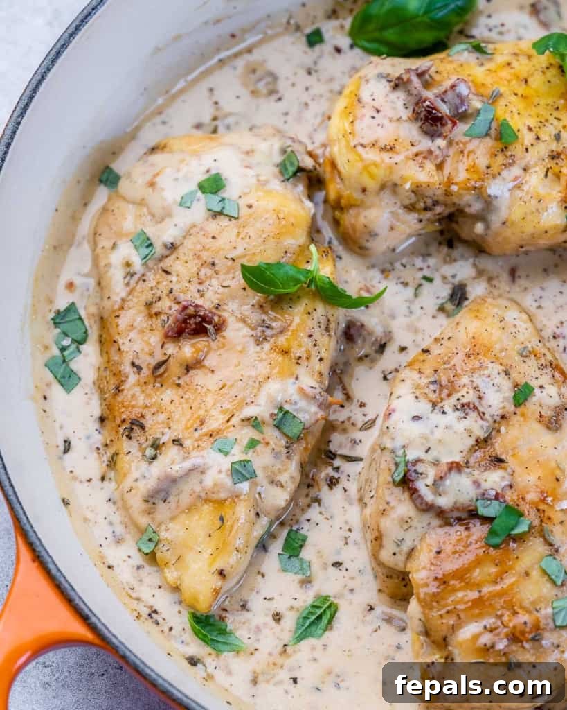 Engagement Skillet Chicken 3 Chicken breast cooking in a creamy sauce garnished with fresh basil.