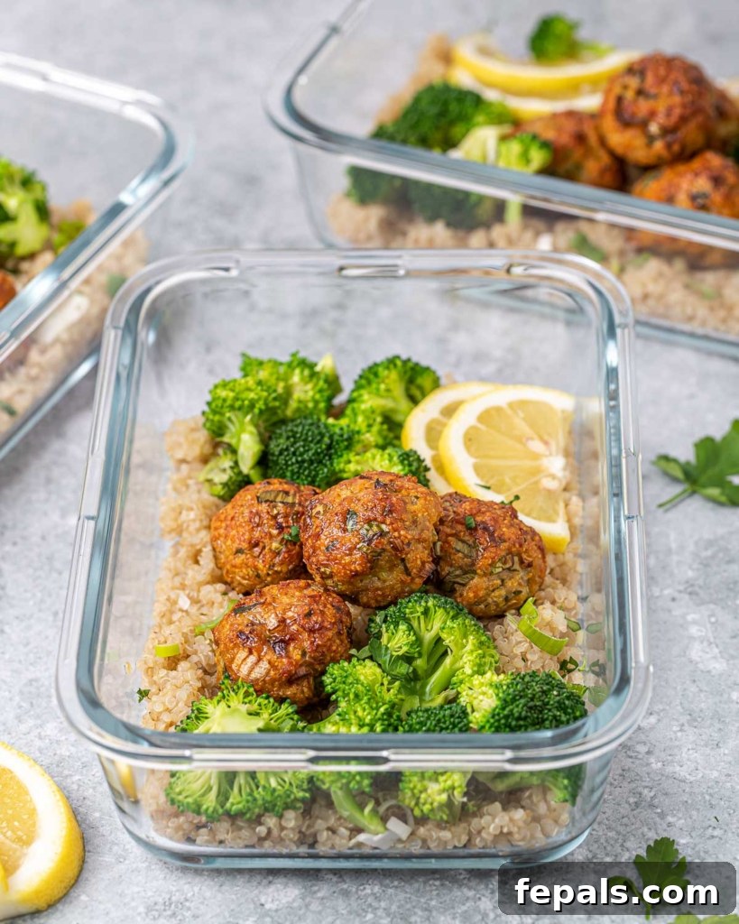 Savory Garlic Chicken Meatball Bowl 9 side shot chicken meatballs in a glass container with broccoli and quinoa