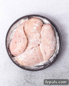 Velvety Ranch Chicken Delight 9 Coating chicken breasts in flour.