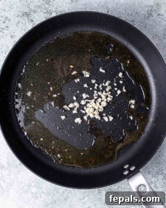Sautéing garlic in a skillet.