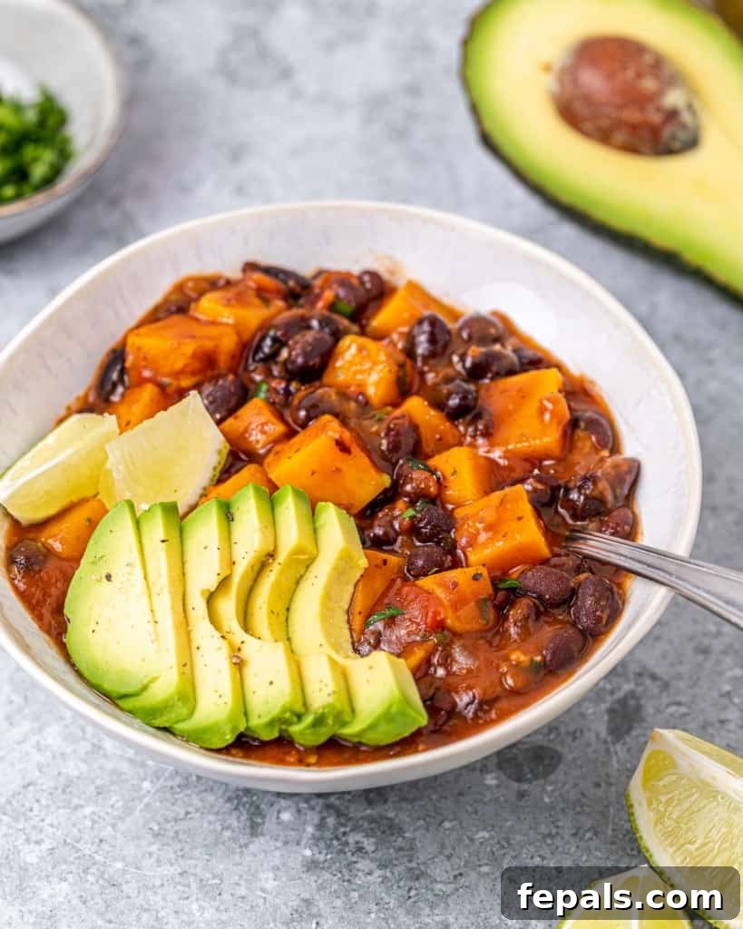 Hearty black bean and sweet potato chili topped with creamy sliced avocado and fresh cilantro.