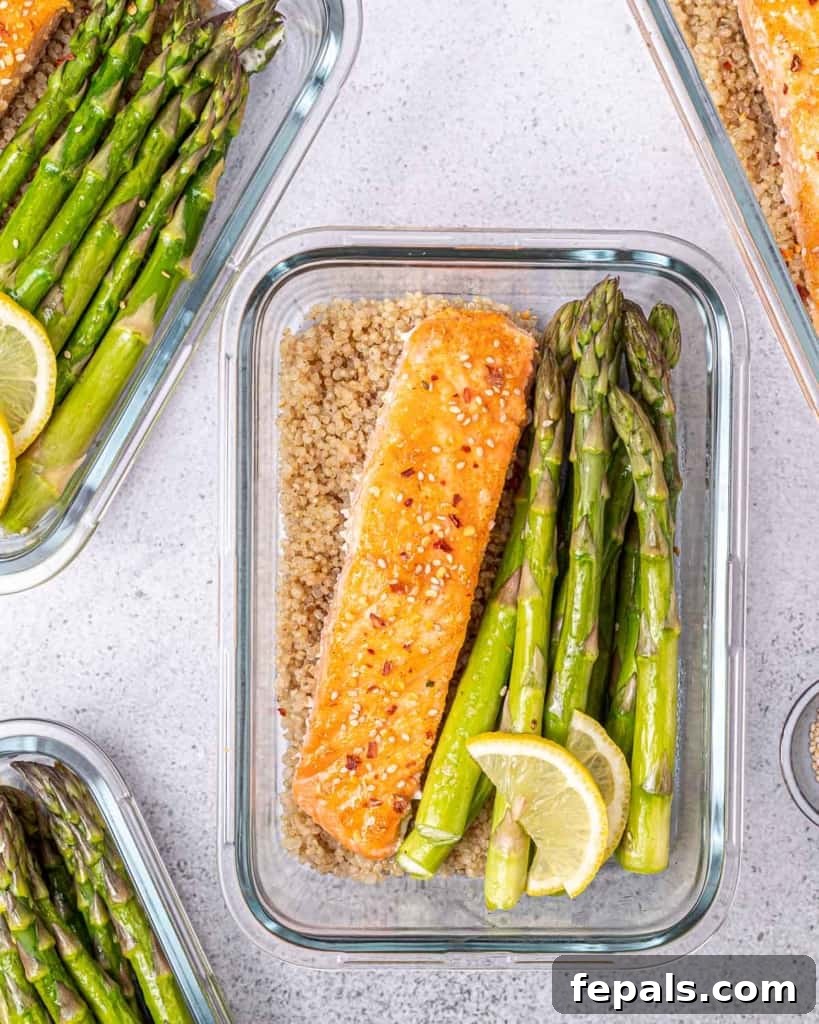 Baked honey salmon and asparagus served in a meal prep bowl.