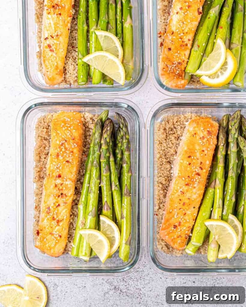 Glass bowls filled with honey salmon, asparagus and quinoa.