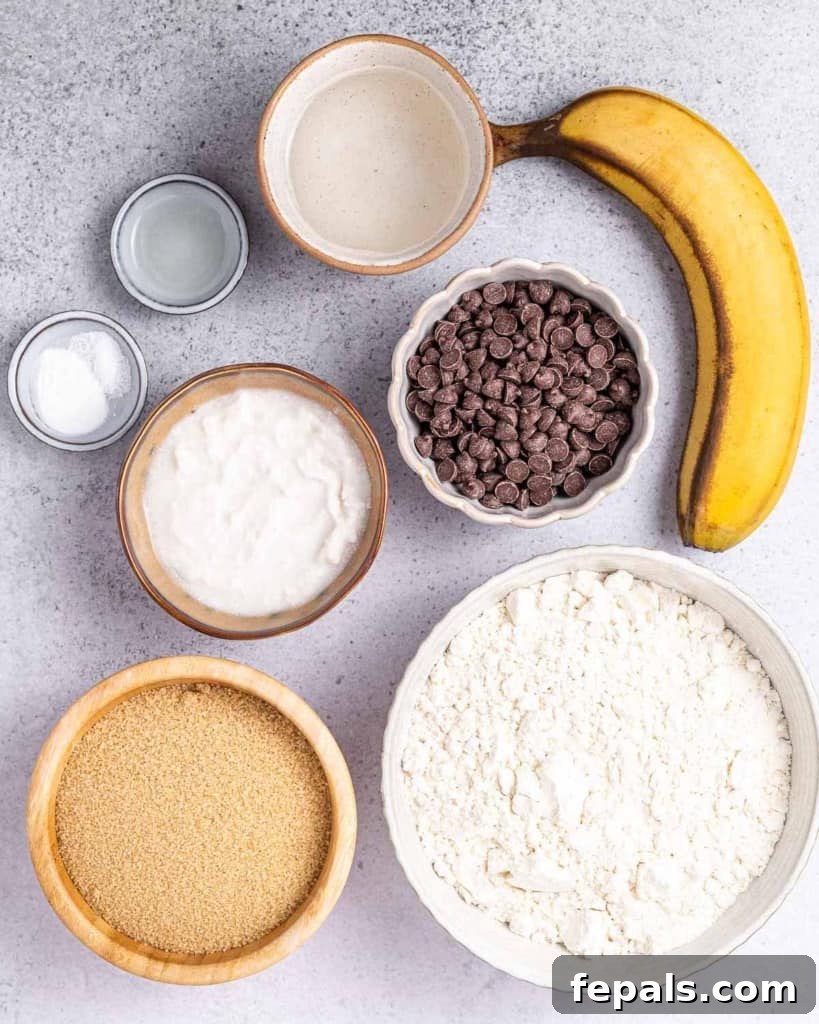 A beautifully arranged flat lay photograph displaying all the fresh ingredients required to bake vegan chocolate chip cookies, neatly organized on a rustic wooden surface.