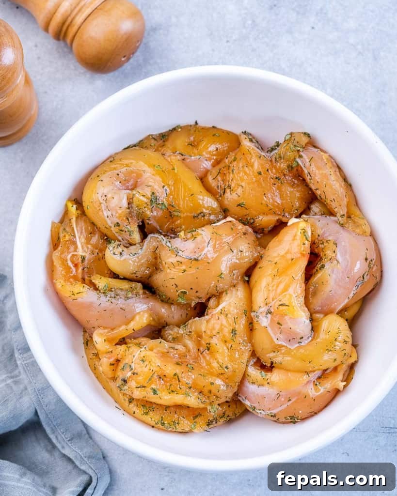 Seasoned chicken tenderloins in a bowl.