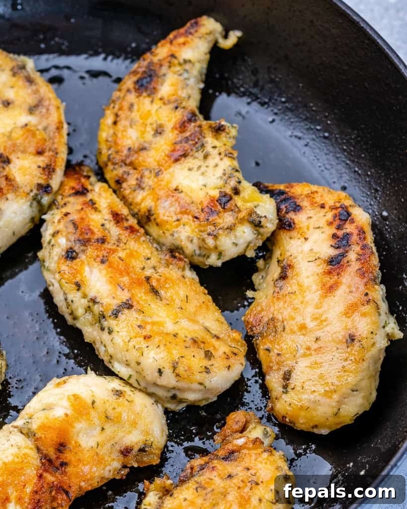 Cooking chicken in a large pan.