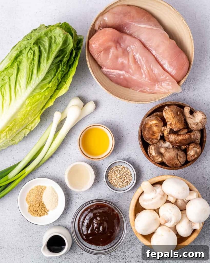 Ingredients for making chicken lettuce wraps divided into small portions on a white counter.