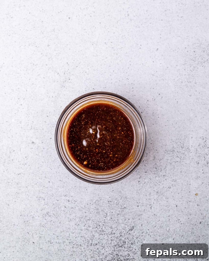 Sauce mixed in a small bowl with a whisk.
