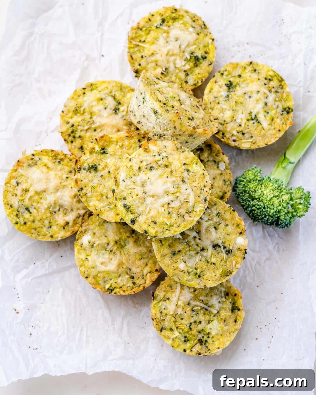 Cheesy Broccoli Quinoa Nuggets 7 Top view of a stack of broccoli cheddar quinoa bites on parchment paper.