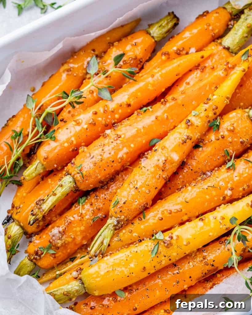 Golden Honey Mustard Carrots 3 Roasted whole carrots in a honey mustard sauce served on a white serving platter, garnished with fresh thyme.