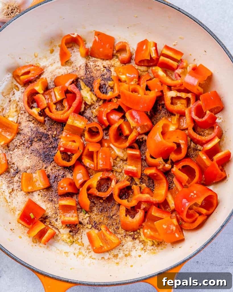 Luscious Garlic Shrimp Skillet Feast 6 Chopped mini sweet peppers being sautéed alongside minced garlic in a skillet.