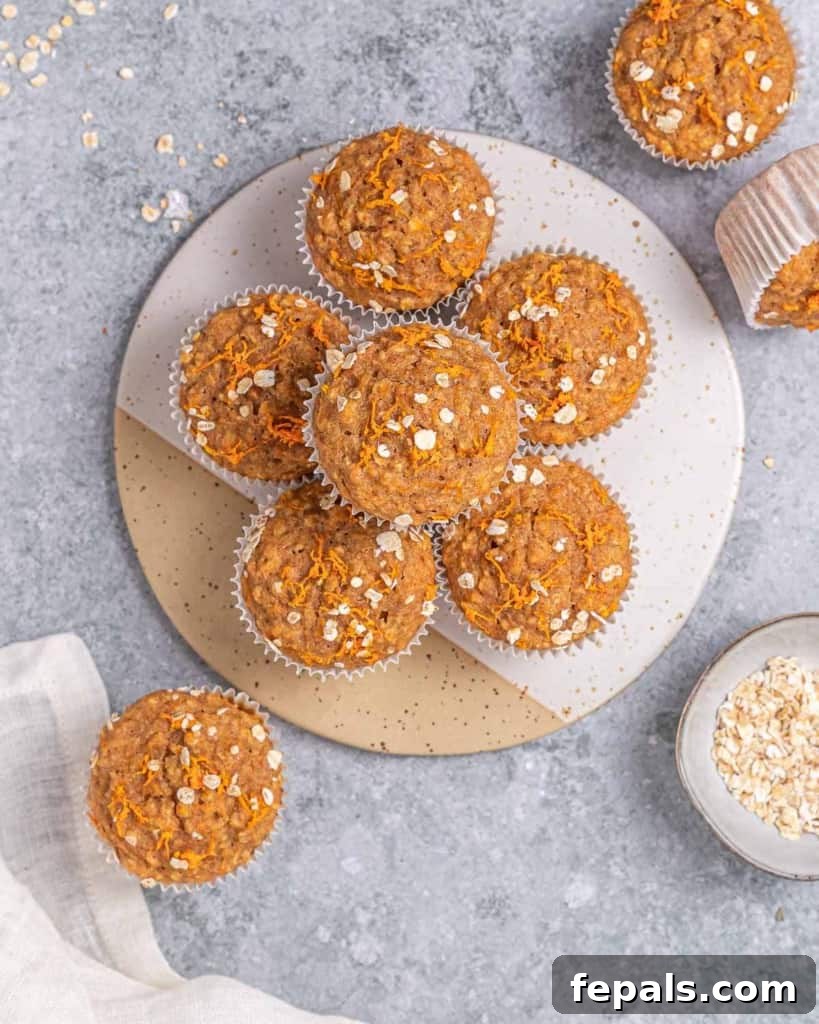 Top-down view of several carrot oat muffins artfully arranged on a round platter.