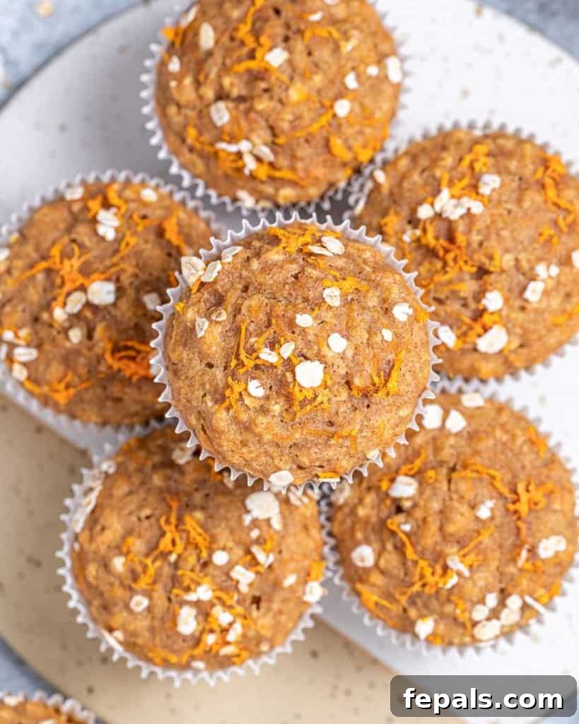 Close-up of baked muffins stacked on a round platter, showing off their golden tops.