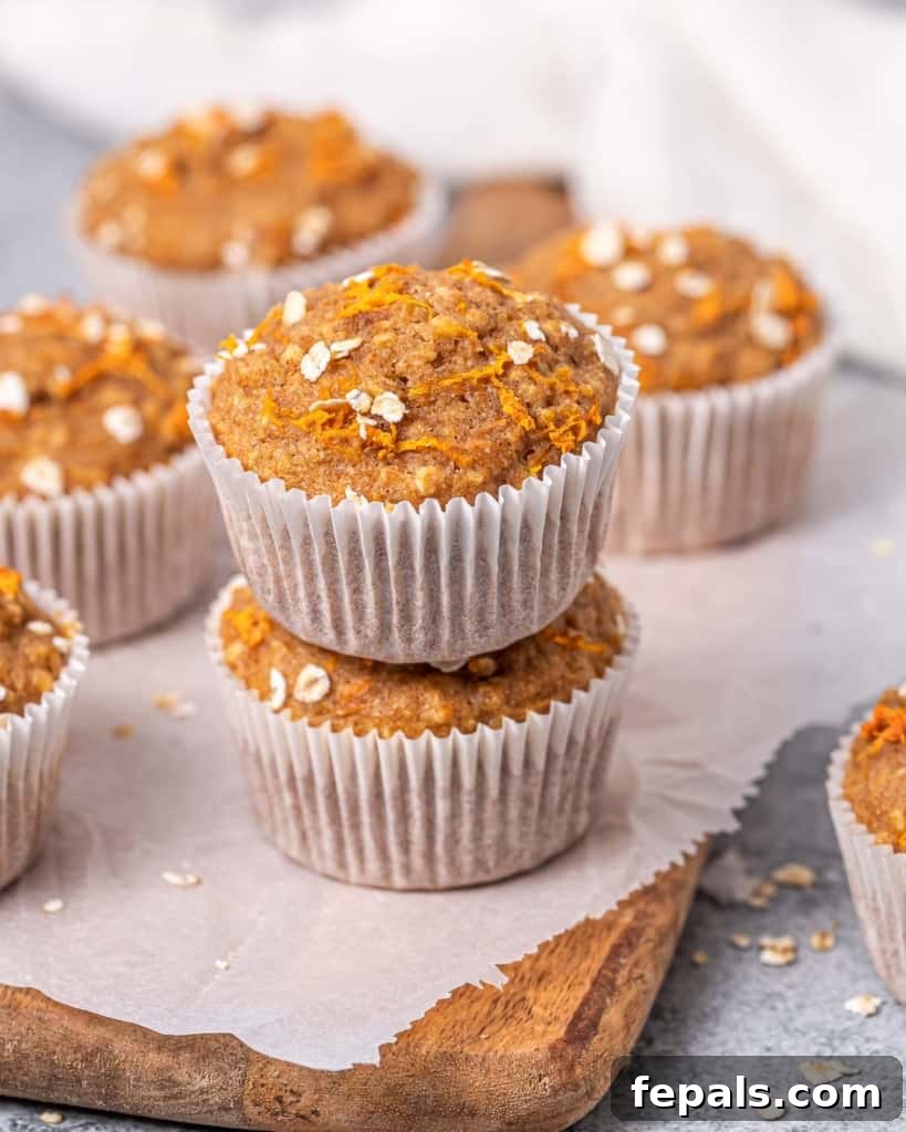Side view of two carrot cake muffins stacked, showcasing their moist crumb.