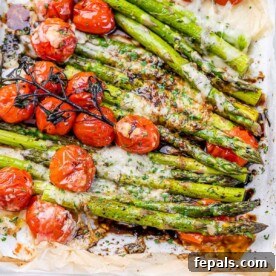 baked asparagus with tomato and topped with parmesan.