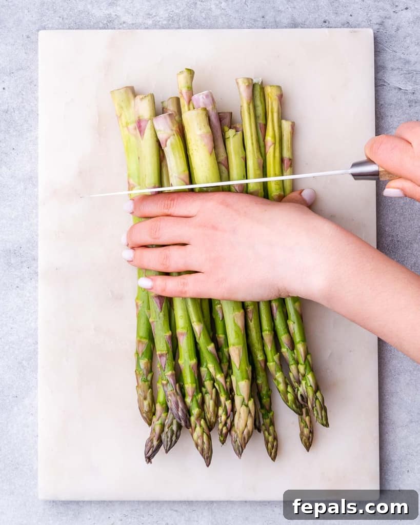 Trimming the ends off of the asparagus.
