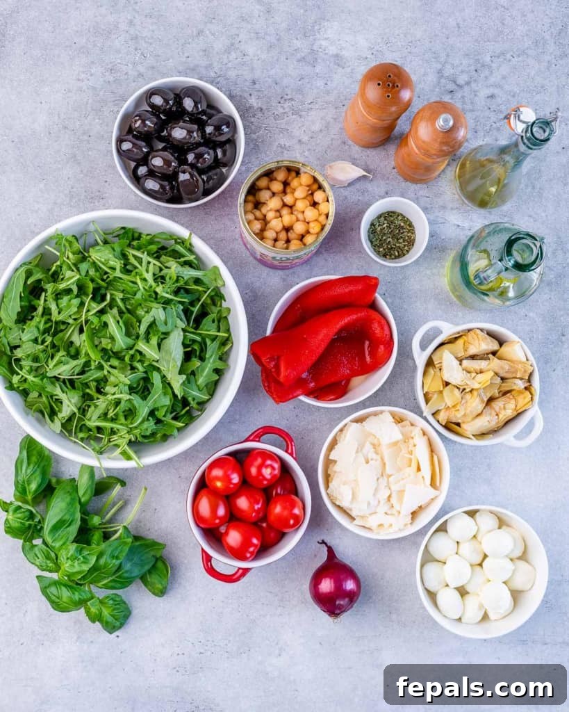 Classic Antipasto Salad 4 An array of fresh vegetables, cheese, and seasoning meticulously arranged in small bowls, showcasing the vibrant and diverse ingredients needed for the Antipasto Salad.