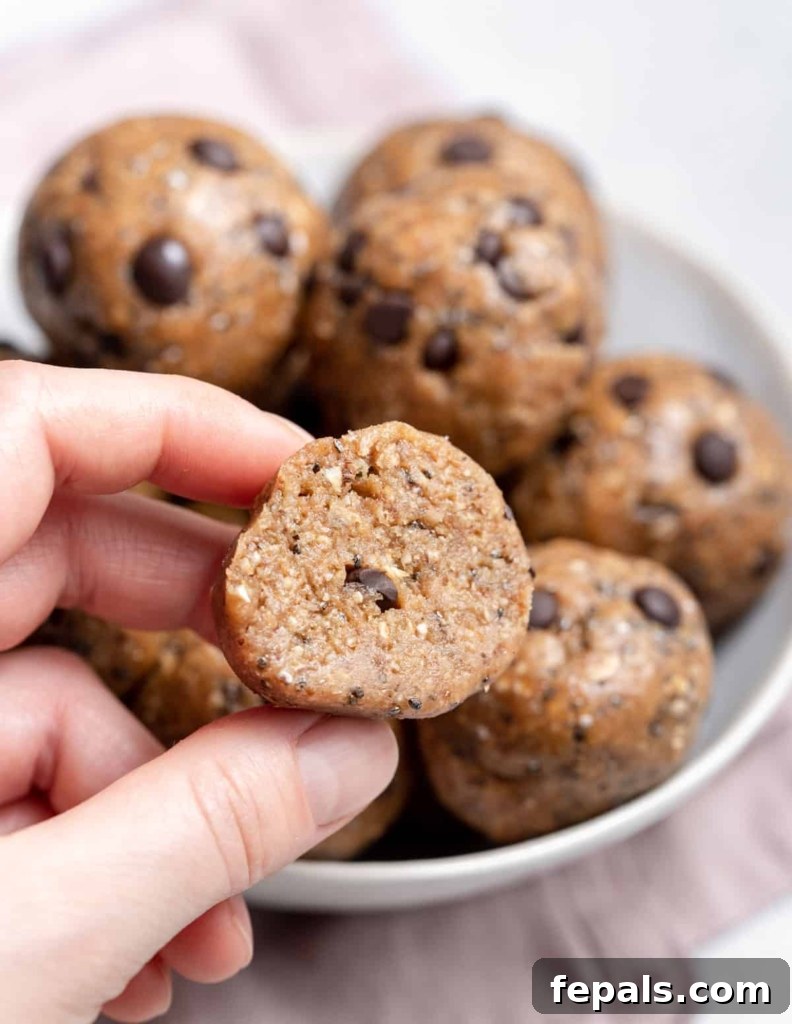 hand holding a piece of cookie dough ball