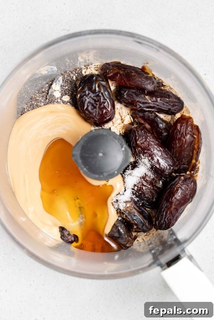 honey added over nut butter, dates, oats, chia seeds in a food processor