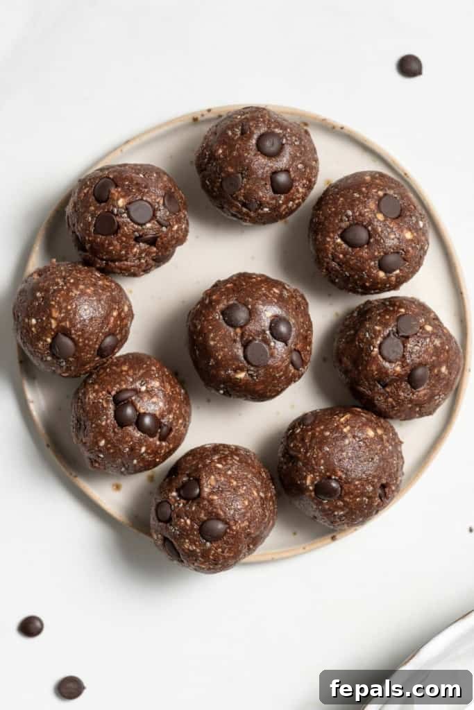 Decadent Double Chocolate Date Energy Bites 11 Top view of multiple chocolate energy balls arranged on a round plate, ready to be enjoyed.