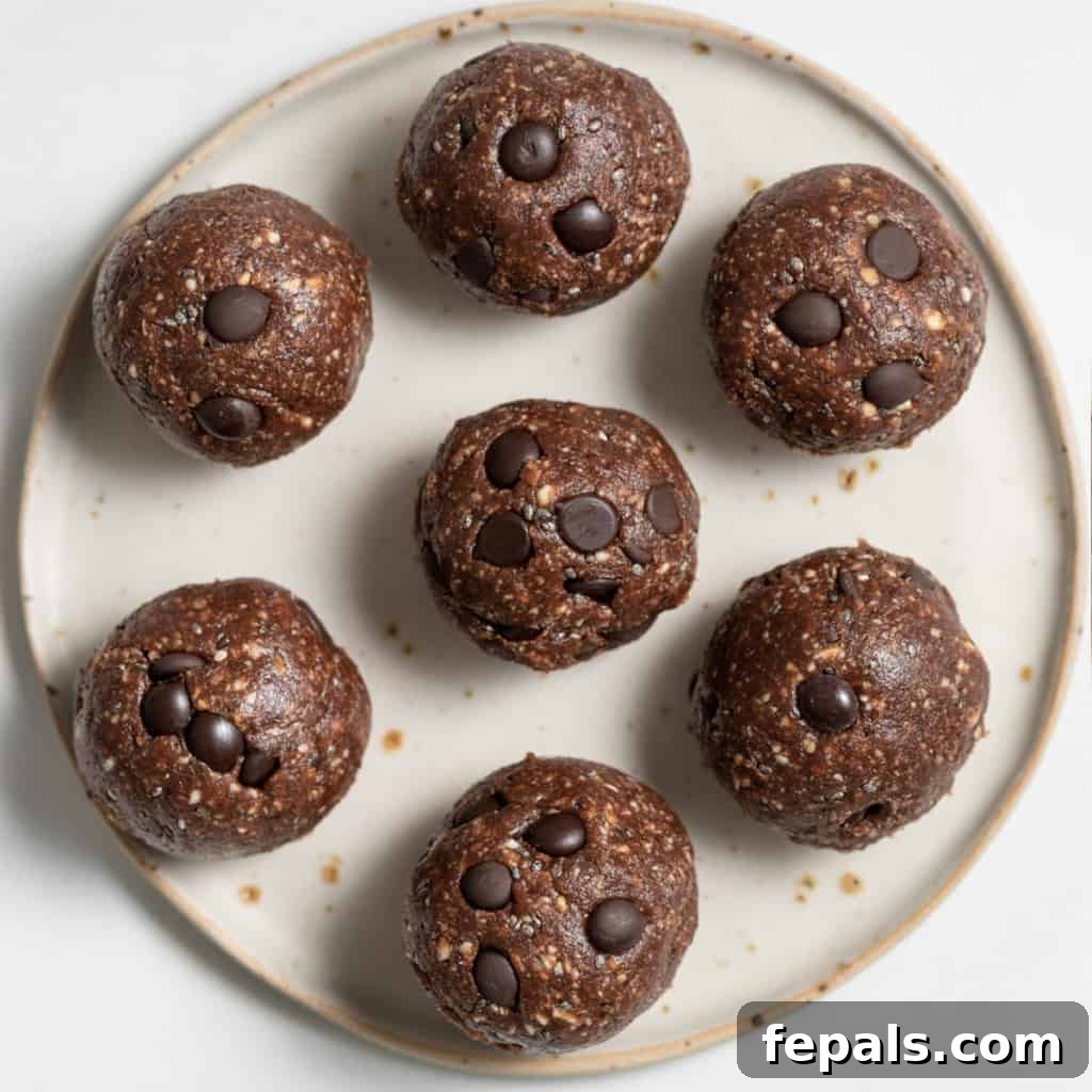 Decadent Double Chocolate Date Energy Bites 17 Top view of chocolate energy bites on a plate, presented enticingly.