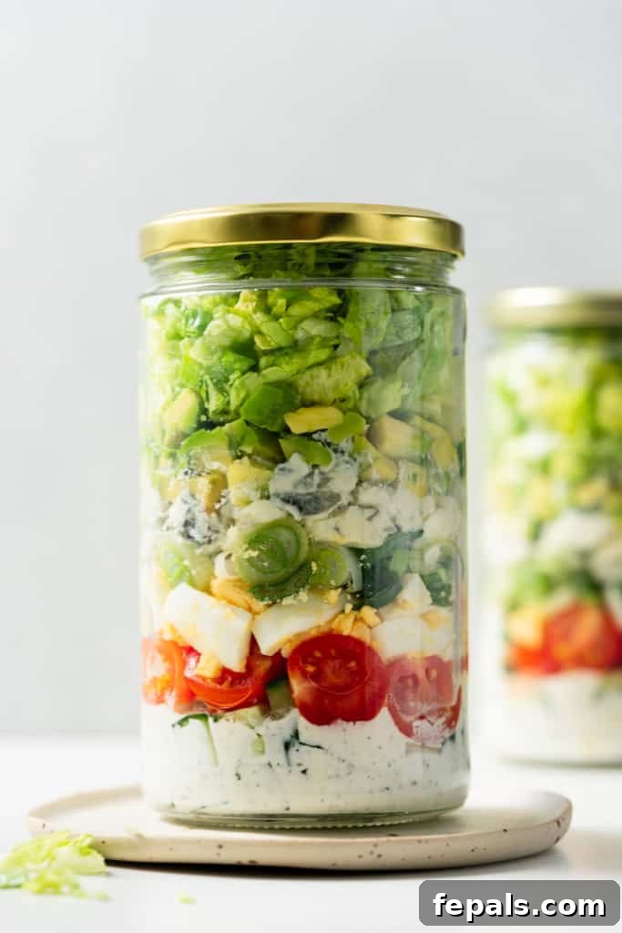 Plant-Powered Cobb Salad 14 Vegetarian Cobb salad stored in a glass jar with a gold lid.