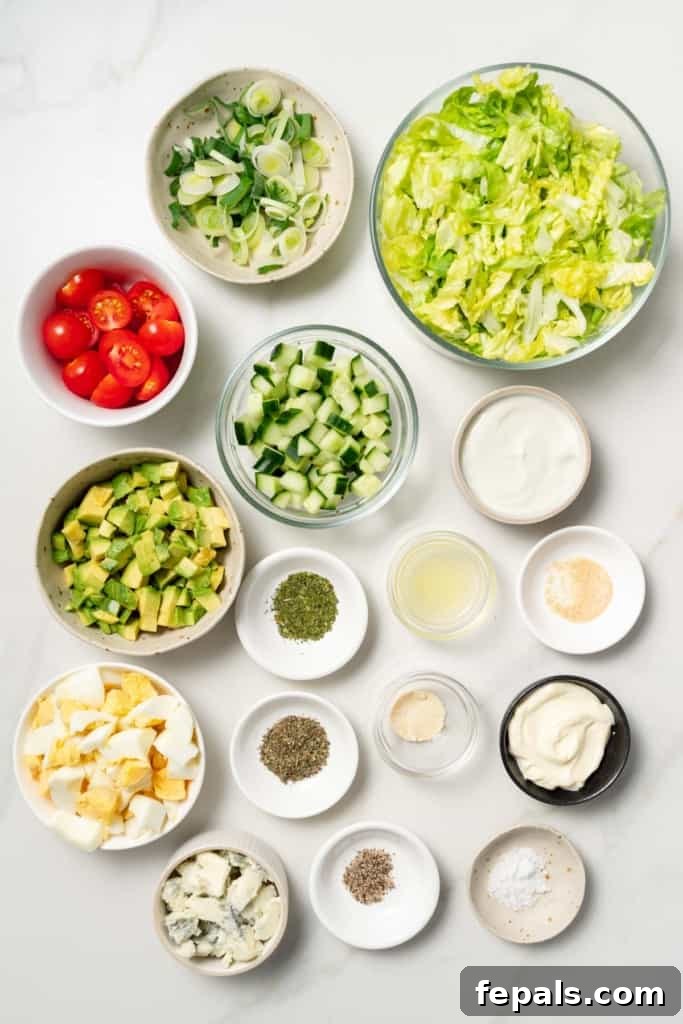 Plant-Powered Cobb Salad 4 Ingredients for making a vegetarian cobb salad divided into small bowls.