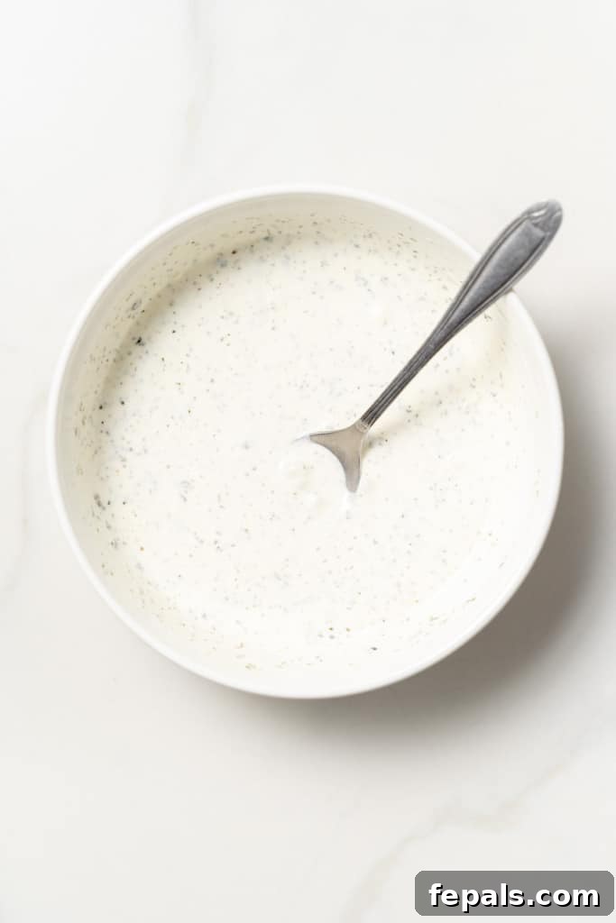 Plant-Powered Cobb Salad 6 Whisking homemade ranch dressing in a bowl.