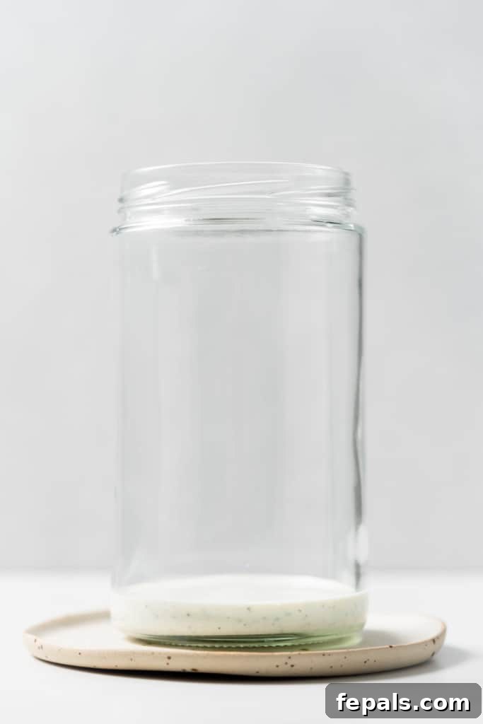 Plant-Powered Cobb Salad 7 Adding dressing to a mason jar.