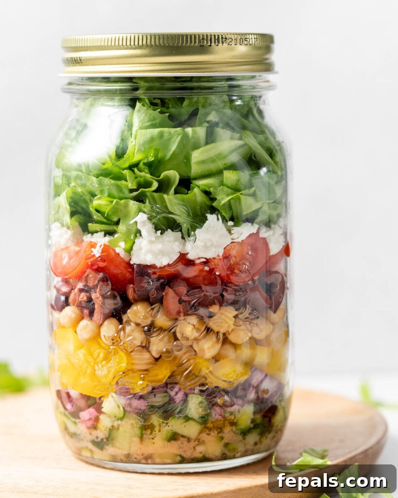 Layered Jar Salads 3 Ingredient for greek salad added so a large mason jar with lid over it