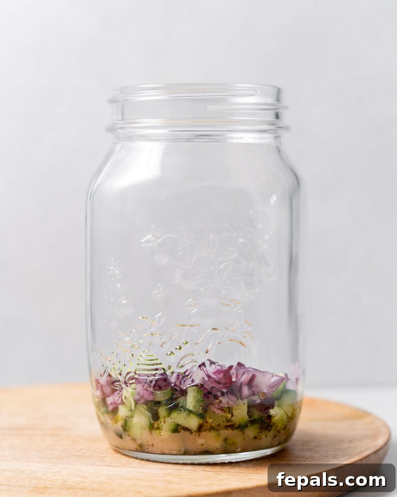 Layered Jar Salads 8 chopped cucumber and chopped onions added over the dressing in the jar