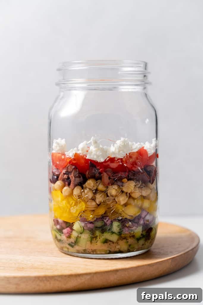 Layered Jar Salads 10 chopped tomatoes and beans added to chickpeas and peppers with other ingredients in the jar