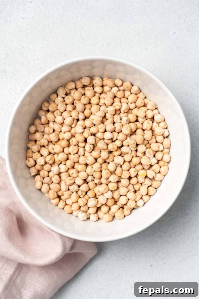 Your Guide to Perfectly Cooked Chickpeas 4 Uncooked chickpeas in a white bowl.